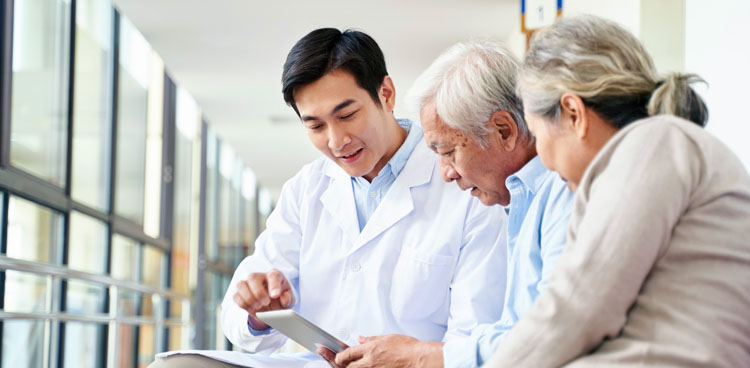 A doctor consults with an elderly couple